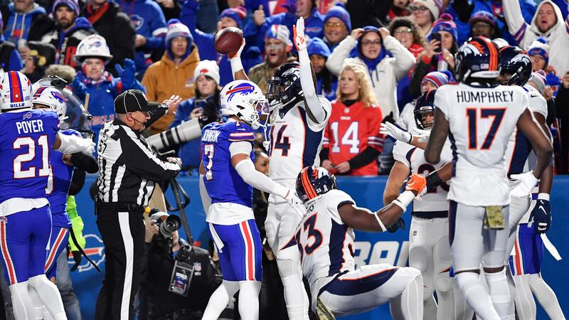 Denver Broncos' Courtland Sutton, center, reacts after he scores a touchdown during the first...