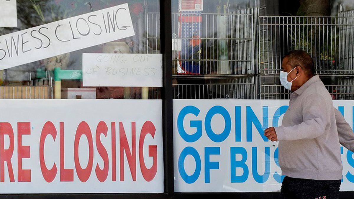 In this May 21, 2020 file photo, a man looks at signs of a closed store due to COVID-19 in Niles, Ill. U.S. businesses shed 2.76 million jobs in May, as the economic damage from the historically unrivaled coronavirus outbreak stretched into a third month. The payroll company ADP reported Wednesday that businesses have let go of a combined 22.6 million jobs since March. (Source: AP Photo/Nam Y. Huh/AP)